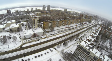 Aerial view to cityscape with wide avenue, residential buildings