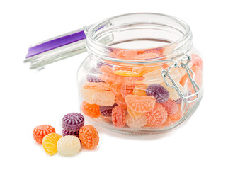 Colorful candy in glass jar on white background
