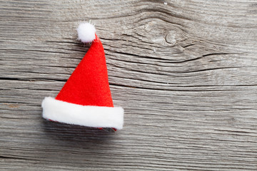 Single Santa Claus red hat on wooden background