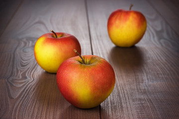 fresh red apples on brown wooden table