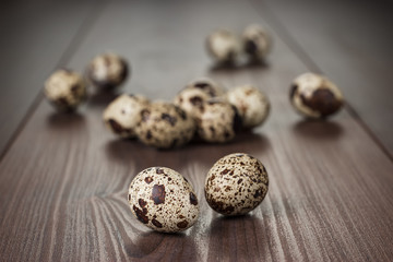 Fototapeta na wymiar quail eggs on the brown wooden table