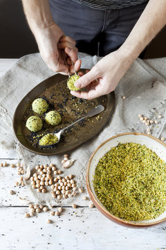 male hands preparing homemade falafel with chickpeas flour