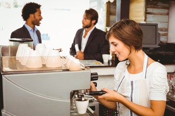 Pretty barista making cup of coffee