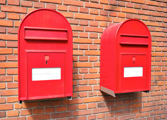 Red mail boxes on brick wall