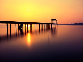 silhouette of jetty at sunrise