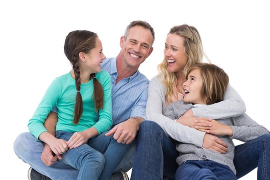 Portrait of a smiling family sitting on the floor
