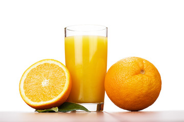 fresh orange and glass with juice over white