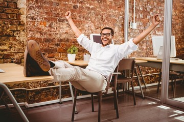 Cheerful businessman cheering in office