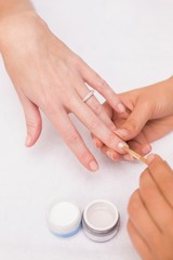 Obraz na płótnie Canvas Nail technician giving customer a manicure