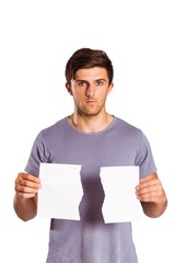 Young man holding ripped paper