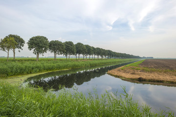 Canal through a rural landscape at fall