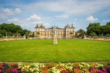 Luxembourg gardens and palace with puffy clouds in Paris