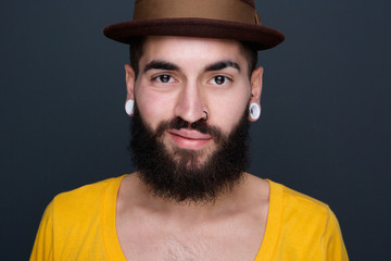 Trendy young man with beard and piercings