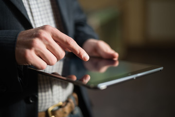 man holding digital tablet, closeup