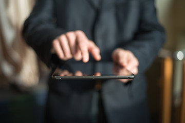 man holding digital tablet, closeup