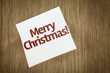 Fototapeta na wymiar Merry Christmas on Paper Note on texture background