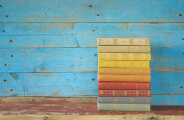 colorful books on a wooden shelf, free copy space