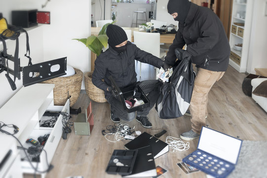 Two burglars at work in an one-family house at daytime