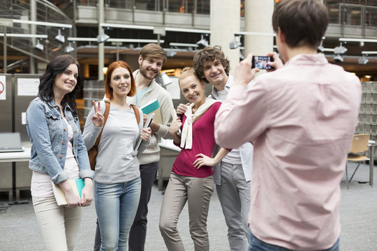 Student taking picture of friends in a university library
