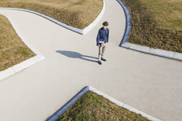 Germany, Baden-Wurttemberg, Teenage boy standing at crossing