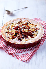 Shortcrust plum tart with coconut crumble
