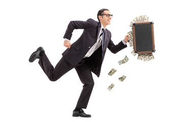 Businessman running with a bag full of money