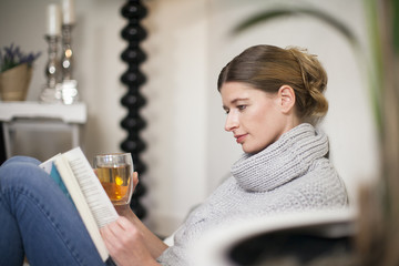 Portrait of reading woman enjoying Sunday morning at home