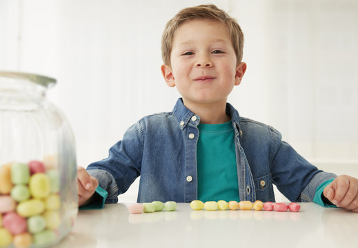 Germany, Munich, Boy with candy jar