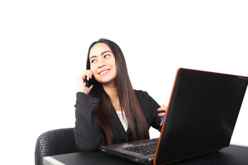 Business woman working on her laptop and talking on the phone