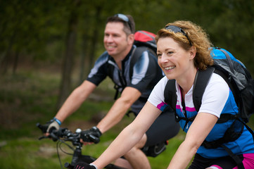 Cheerful couple enjoying a bike ride in nature