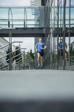 Germany, Baden-Wuerttemberg, Mannheim, mature jogger running in the city
