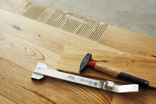 Laying finished oak parquet flooring, close-up