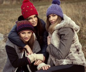 Happy tree girls wearing a woolly hats
