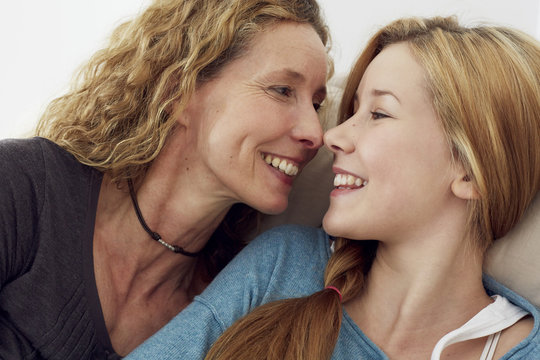 Portrait of mother and daughter having fun at home