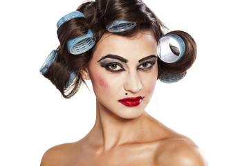Funny woman with curlers and bad makeup
