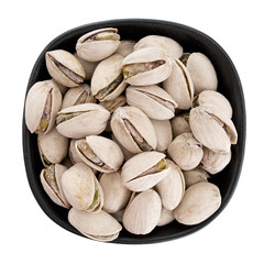 Pistachio nuts in bow, isolated.  Pistacia vera.