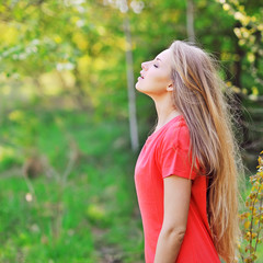 Young happy smiling woman doing deep breath