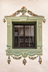 Traditional painted decoration around a window, Tyrol, Austria
