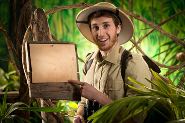 Cheerful explorer with sign