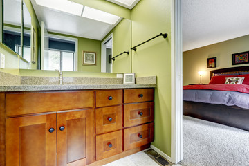 Master bedroom with light green tone bathroom