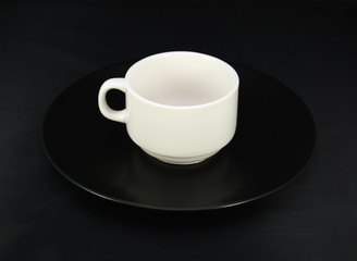 Cup and saucer on black background