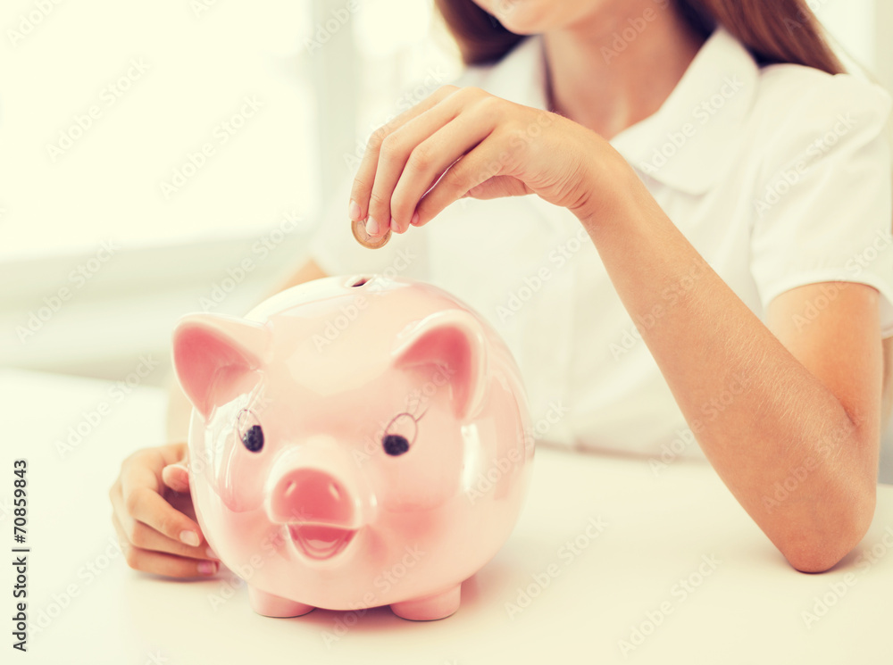 Poster smiling child putting coin into big piggy bank