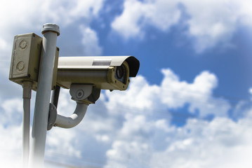 CCTV security camera under blue sky