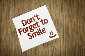 Don't Forget to Smile on Paper Note on texture background