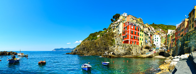 Riomaggiore village panorama, rocks, boats and sea. Cinque Terre