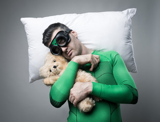 Superhero sleeping on a pillow floating in the air