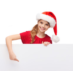 child in santa helper hat with blank white board