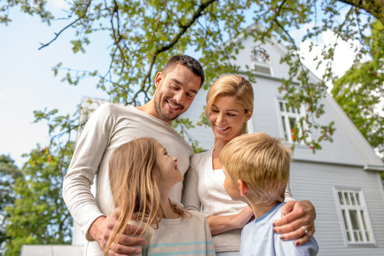 Happy Family In Front Of House Outdoors