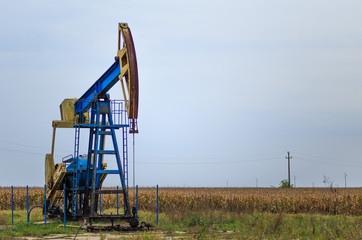 Fototapeta na wymiar Active oil and gas pump in remote rural area