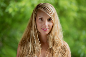 Naklejka premium beautiful girl with blond hair at green background